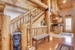 Arrow Lodge- Log stair case and spacious main floor.